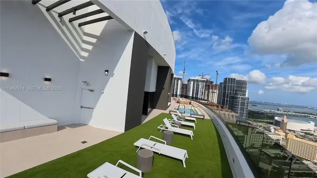 a view of a house with pool and chairs