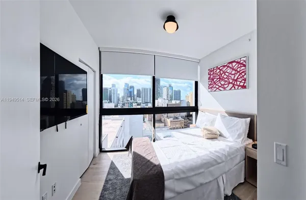 a bedroom with a bed and glass window