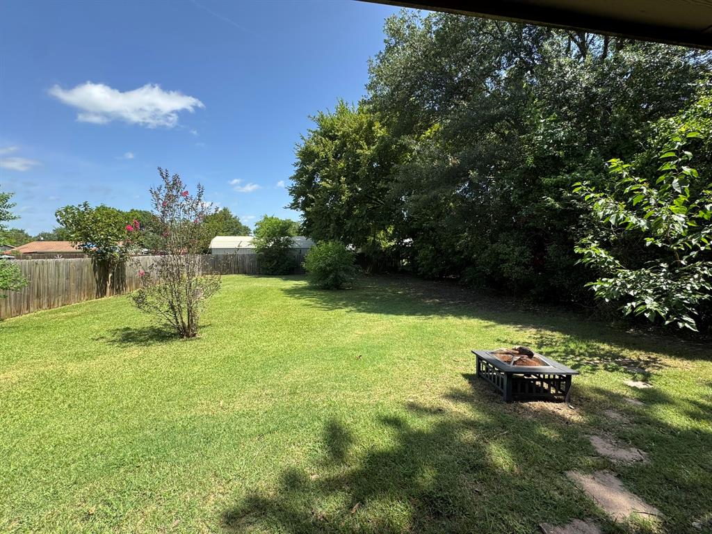 705 East James Street Wills Point, TX 75169 - Photo 13 of 26 a view of a garden with a bench