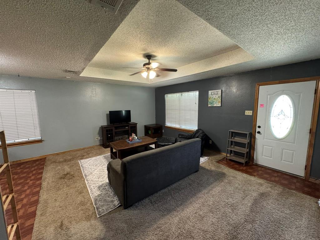 705 East James Street Wills Point, TX 75169 - Photo 17 of 26 a living room with furniture a ceiling fan and a window