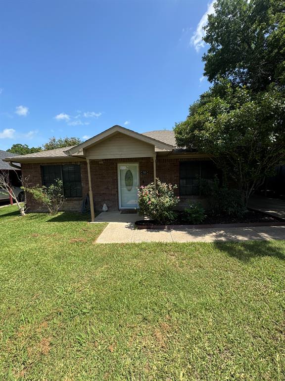 705 East James Street Wills Point, TX 75169 - Photo 18 of 26 a front view of a house with a yard