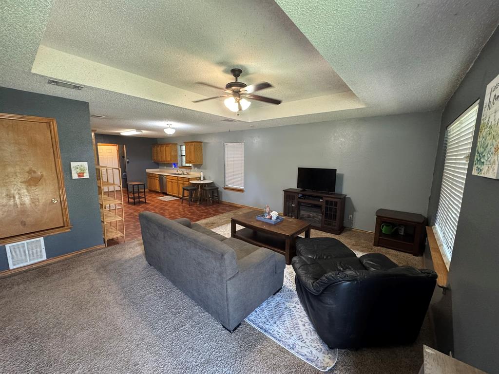 705 East James Street Wills Point, TX 75169 - Photo 2 of 26 a living room with furniture and a flat screen tv