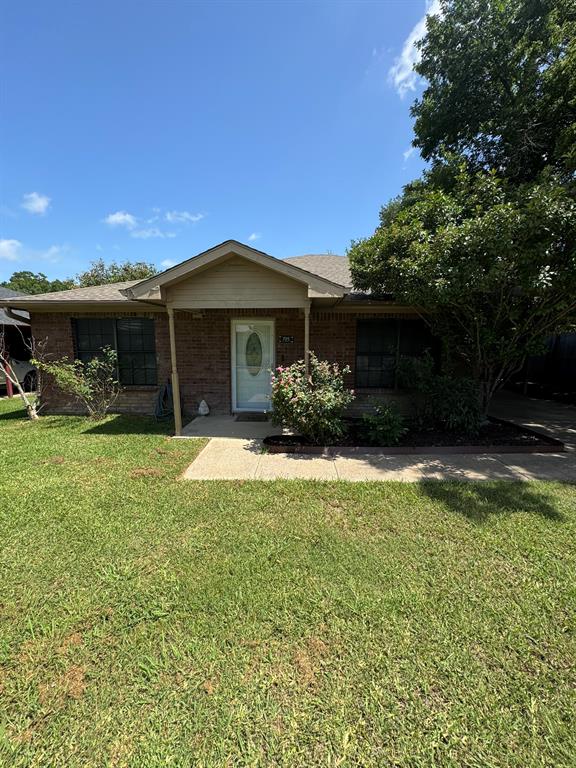 705 East James Street Wills Point, TX 75169 - Photo 23 of 26 a front view of a house with a yard