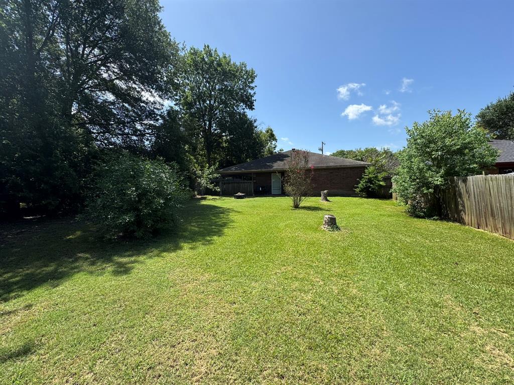 705 East James Street Wills Point, TX 75169 - Photo 24 of 26 a swimming pool with trees in the background