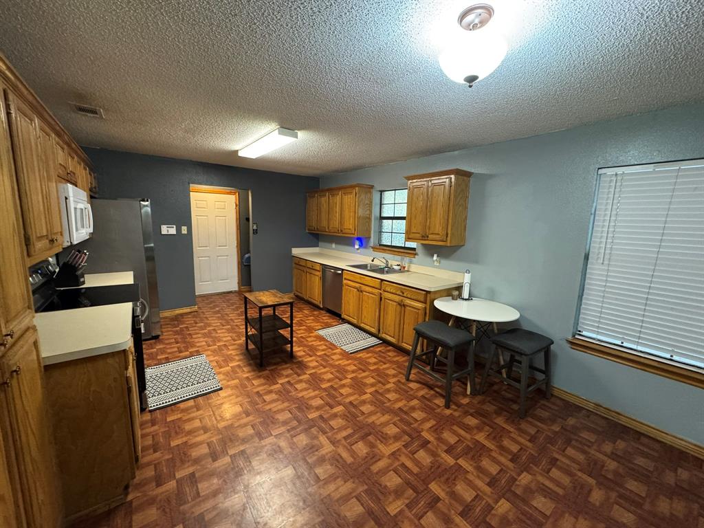 705 East James Street Wills Point, TX 75169 - Photo 3 of 26 a kitchen with a sink cabinets and window