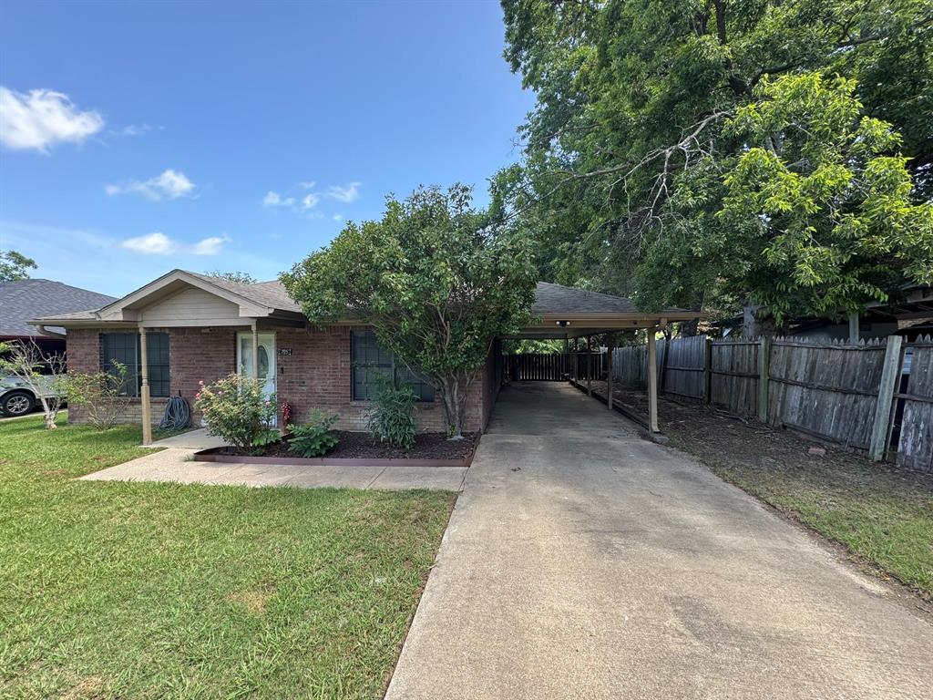 705 East James Street Wills Point, TX 75169 - Photo 5 of 26 a view of a house with a yard and sitting area
