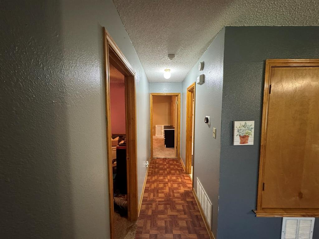705 East James Street Wills Point, TX 75169 - Photo 9 of 26 a view of a hallway with wooden floor