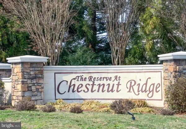 a kitchen with stainless steel appliances granite countertop a stove top oven a sink dishwasher and a microwave oven on the wooden floor