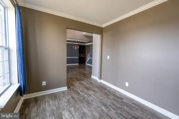 a view of a room with wooden floor and a fireplace