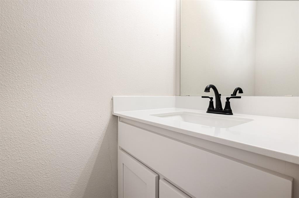 7221 Bayhill Drive Rowlett, TX 75088 - Photo 8 of 18 Bathroom featuring vanity and a textured wall
