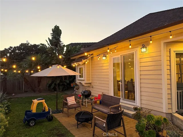 a backyard of a house with yard fire pit and outdoor seating