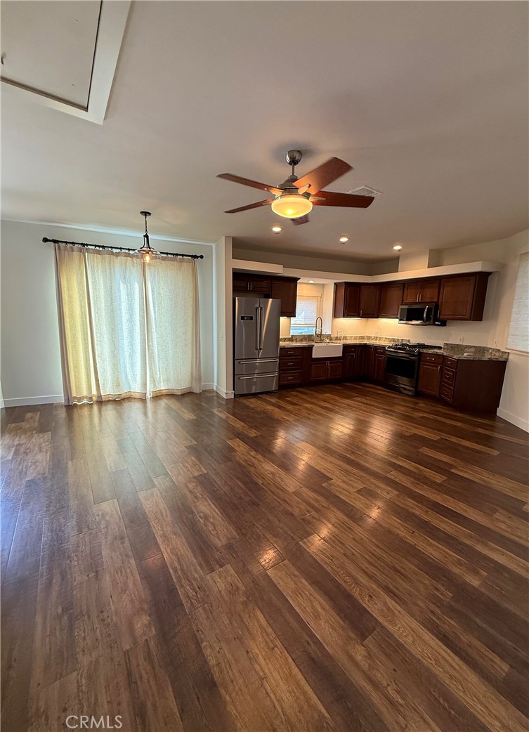 25955 Via Del Rey, Unit B San Juan Capistrano, CA 92675 - Photo 17 of 20 a view of an empty room with wooden floor and a window