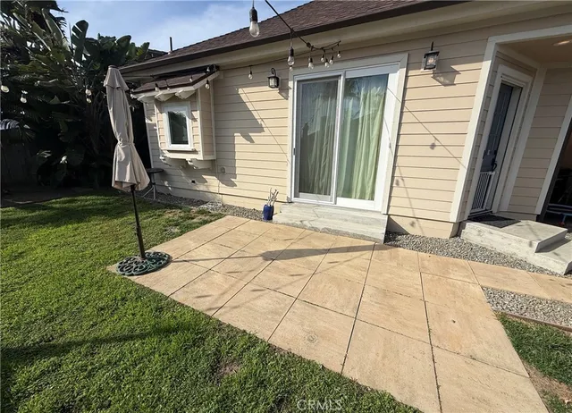 a backyard of a house with yard and barbeque oven