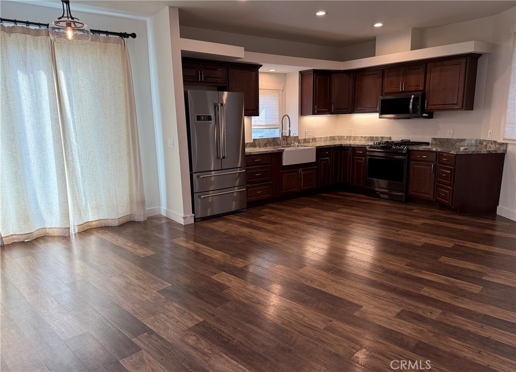 25955 Via Del Rey, Unit B San Juan Capistrano, CA 92675 - Photo 5 of 20 a kitchen with stainless steel appliances granite countertop a refrigerator and a stove top oven