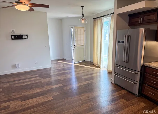 a view of a refrigerator in kitchen and wooden floor