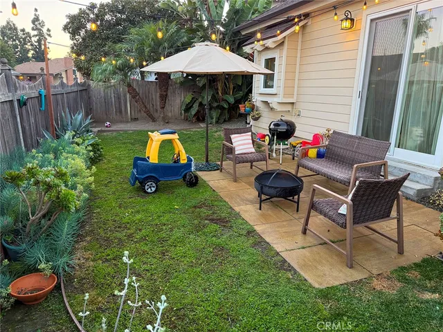 a backyard of a house with table and chairs