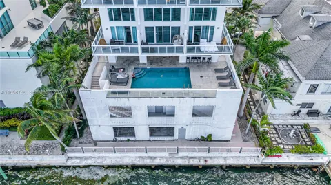 a view of swimming pool with outdoor seating and plants