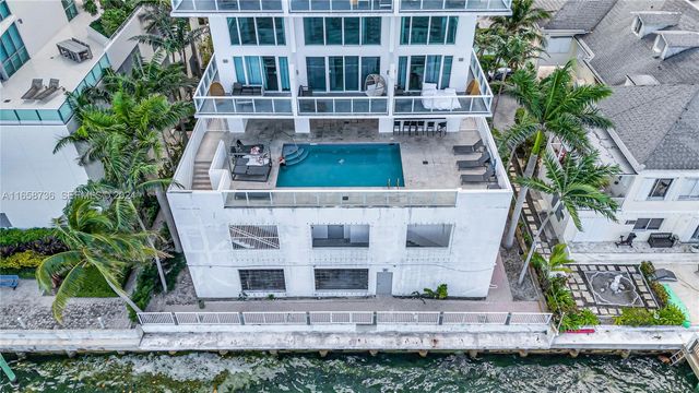 a view of swimming pool with outdoor seating and plants
