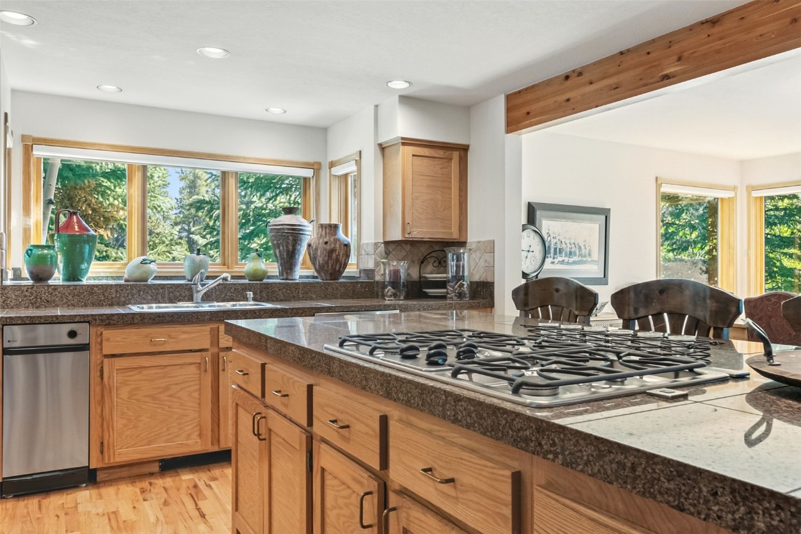 272 Penstemon Road Keystone, CO 80435 - Photo 11 of 50 a kitchen with stainless steel appliances granite countertop a stove a sink and white cabinets