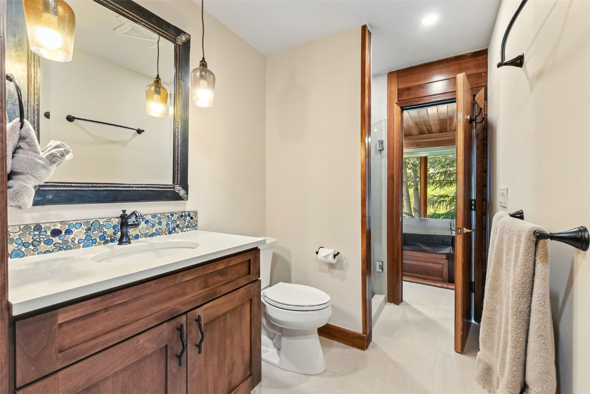 272 Penstemon Road Keystone, CO 80435 - Photo 19 of 50 a bathroom with a toilet sink and mirror