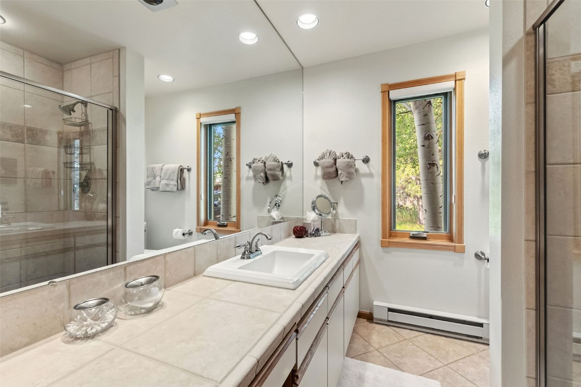 272 Penstemon Road Keystone, CO 80435 - Photo 25 of 50 a bathroom with a granite countertop sink mirror and double