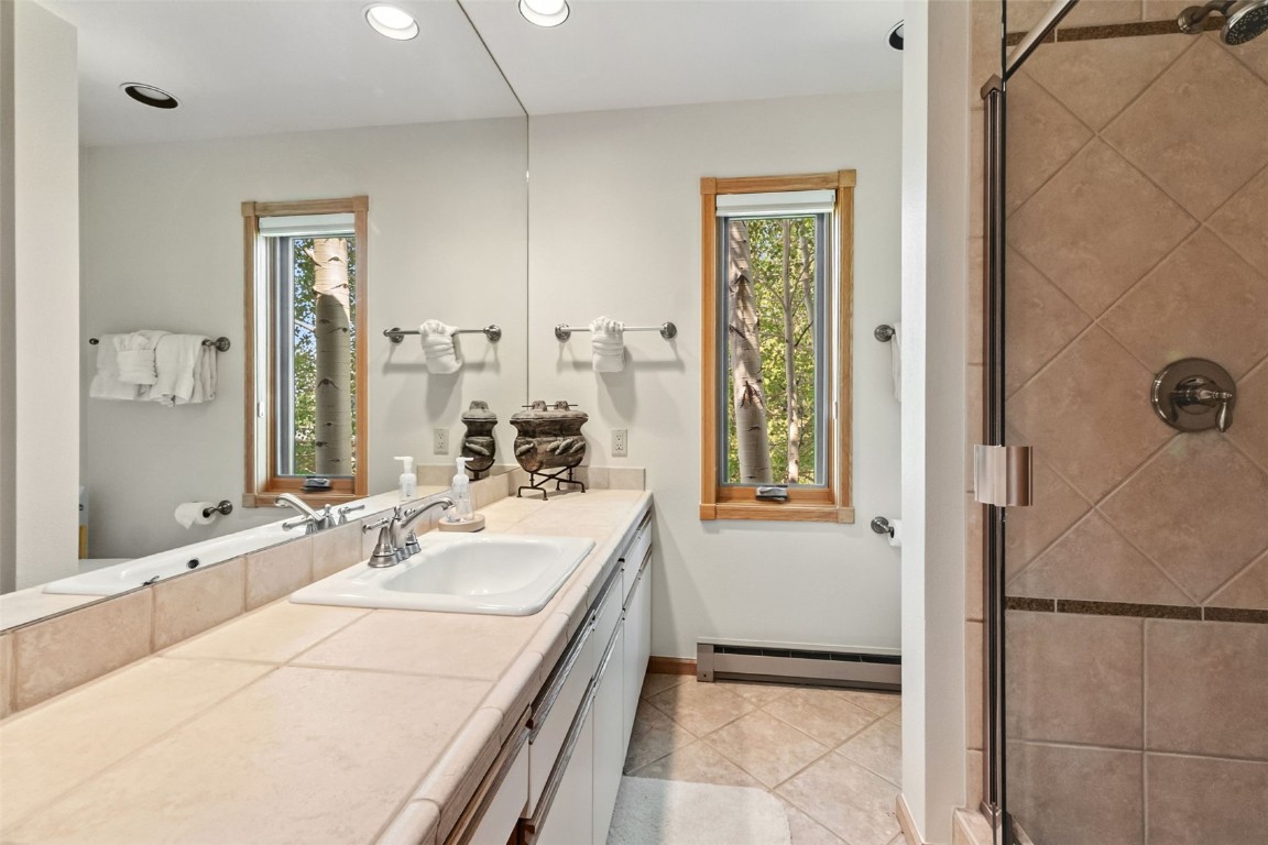 272 Penstemon Road Keystone, CO 80435 - Photo 33 of 50 a bathroom with a tub sink and mirror