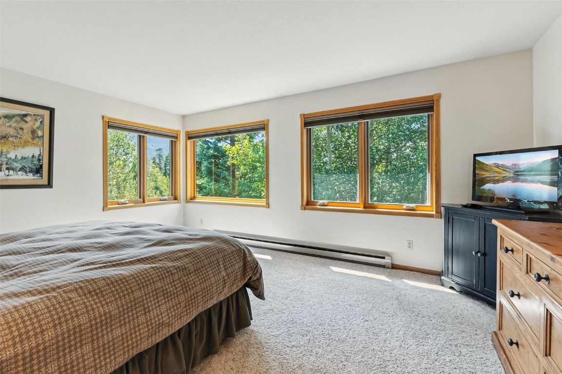 272 Penstemon Road Keystone, CO 80435 - Photo 34 of 50 a bedroom with a bed and a flat tv screen on dresser