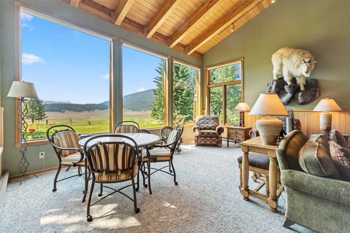 272 Penstemon Road Keystone, CO 80435 - Photo 4 of 50 a view of a dining room with furniture water chandelier and wooden floor