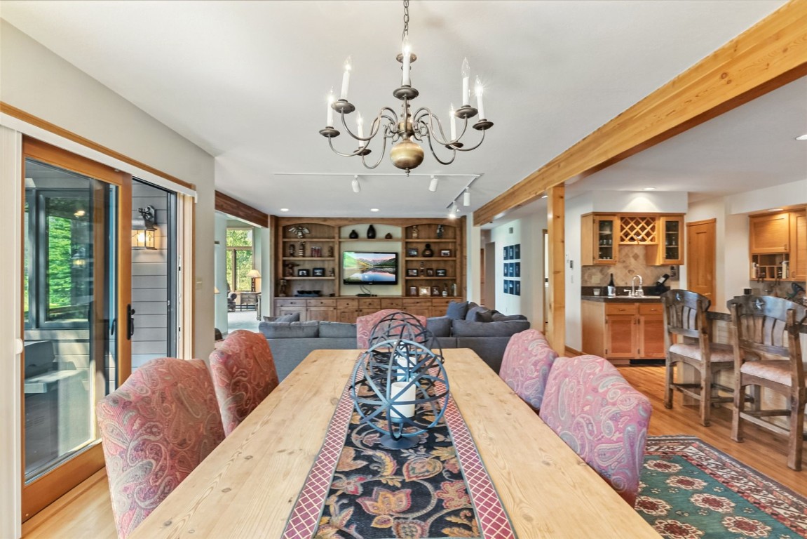 272 Penstemon Road Keystone, CO 80435 - Photo 7 of 50 a spacious bedroom with a large bed and a chandelier