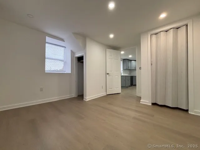 a view of empty room with a kitchen
