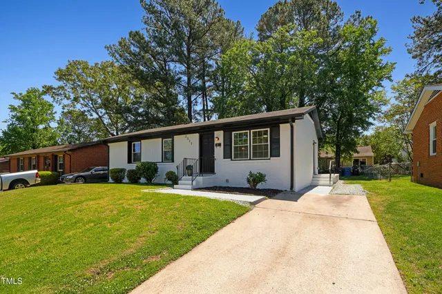 a front view of house with yard and green space