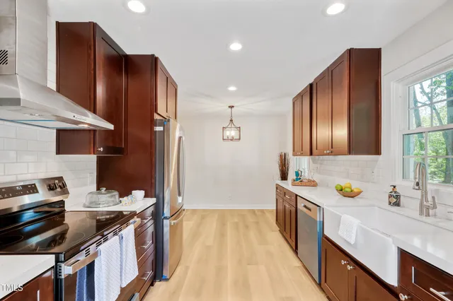 a kitchen with a sink stove and cabinets