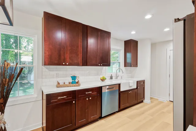 a spacious bathroom with double vanity and a mirror