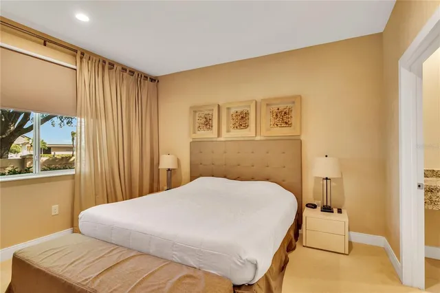 a bed sitting in a bedroom next to a window