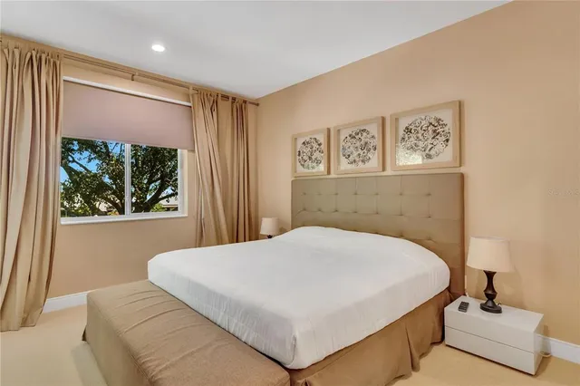 a bedroom with a large bed and a window