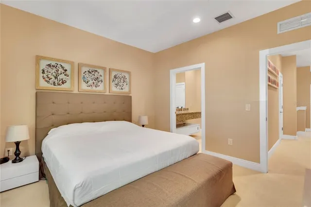 a bedroom with a large bed and a couch