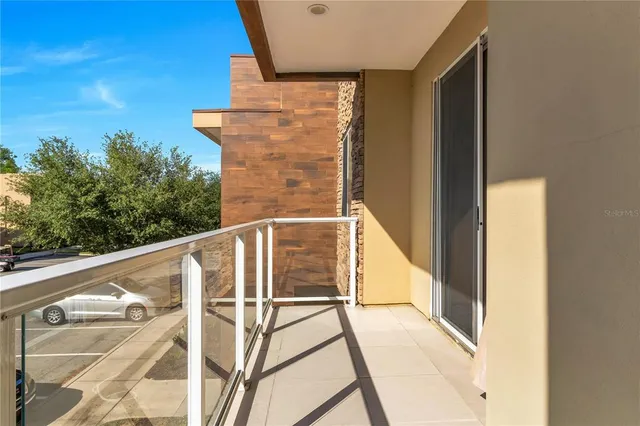 a view of balcony with wooden floor and fence