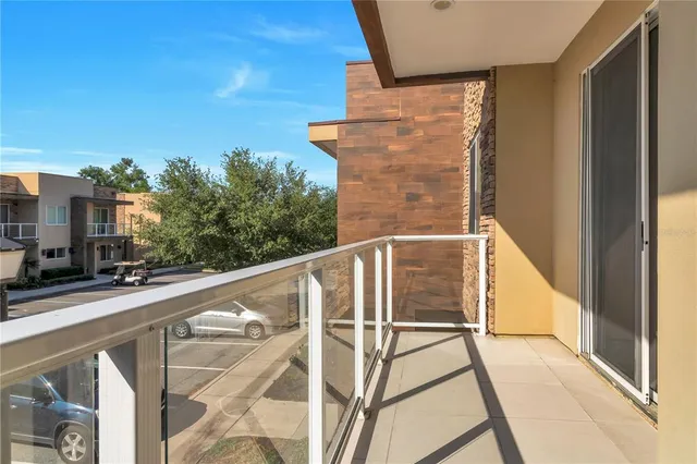 a view of balcony with wooden floor and fence