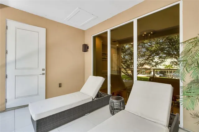 a view of a bedroom with furniture and window