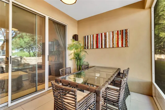 a dining room with furniture and a floor to ceiling window