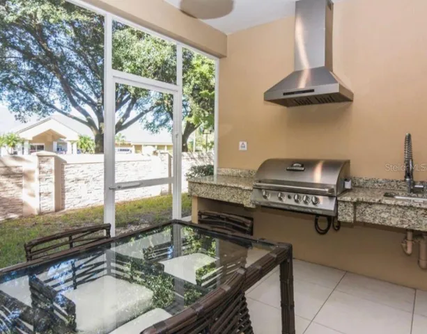 a kitchen with a stove a sink and a cabinet