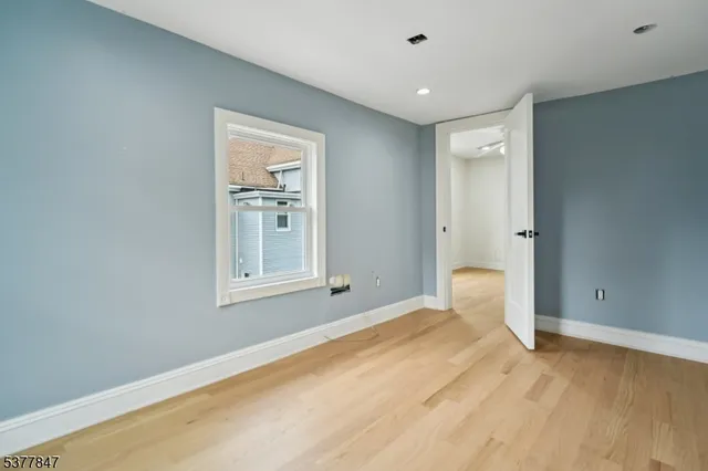 a view of a room with wooden floor and cabinet