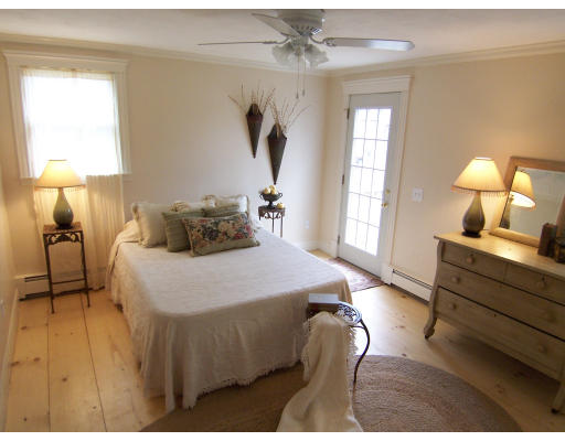 67 Green Street, Unit B Marblehead, MA 01945 - Photo 2 of 11 a bedroom with a bed window and wall painting
