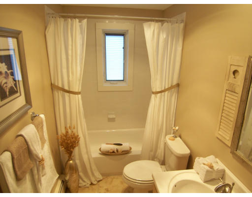 67 Green Street, Unit B Marblehead, MA 01945 - Photo 8 of 11 a bathroom with a granite countertop sink and a mirror