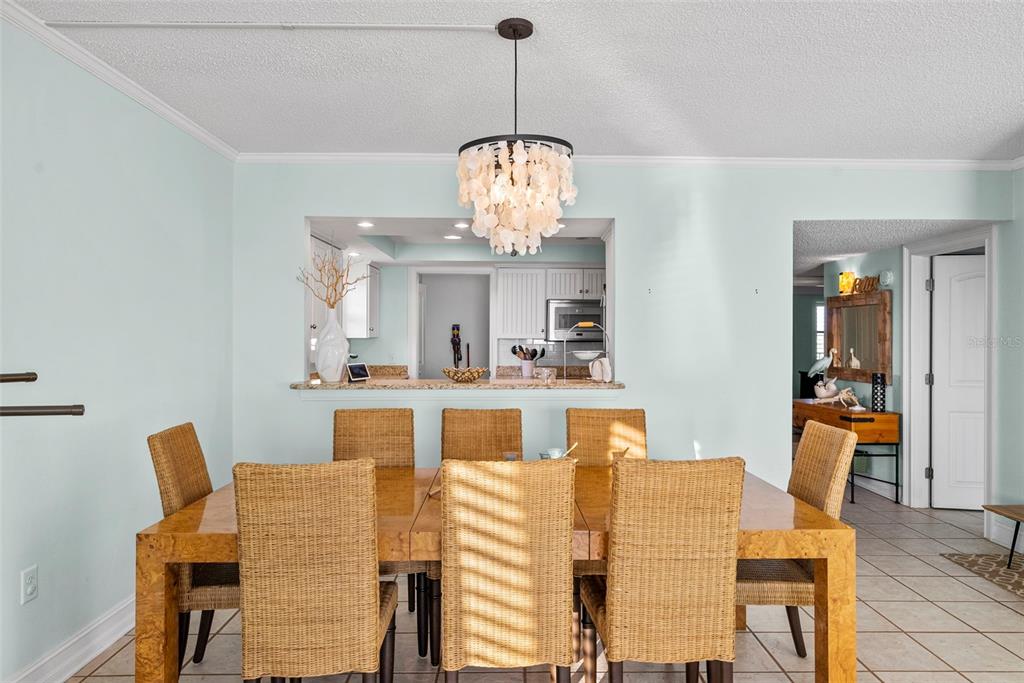 13650 Gulf Boulevard, Unit 604 Madeira Beach, FL 33708 - Photo 17 of 71 a dining room with furniture and window
