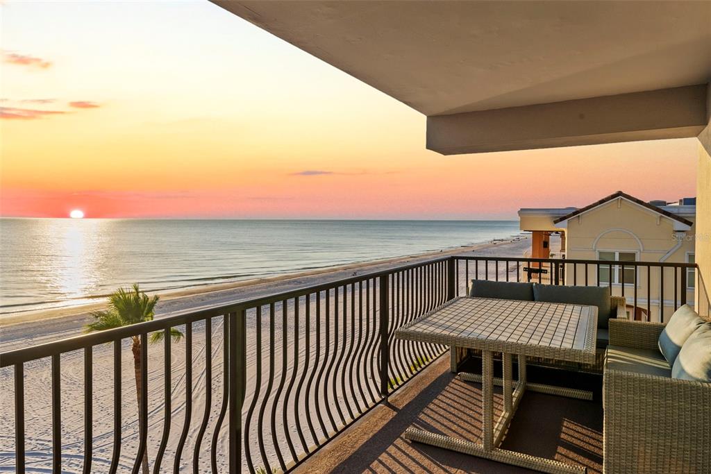 13650 Gulf Boulevard, Unit 604 Madeira Beach, FL 33708 - Photo 20 of 71 a view of a balcony with wooden floor space and outdoor seating