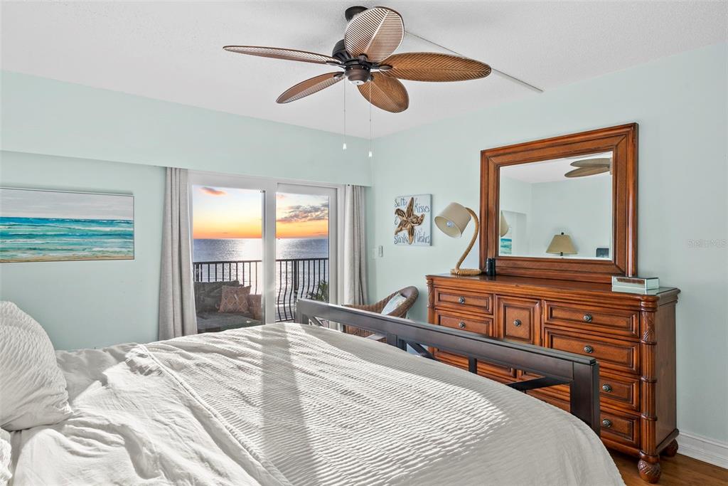 13650 Gulf Boulevard, Unit 604 Madeira Beach, FL 33708 - Photo 32 of 71 a bedroom with a bed and a chandelier