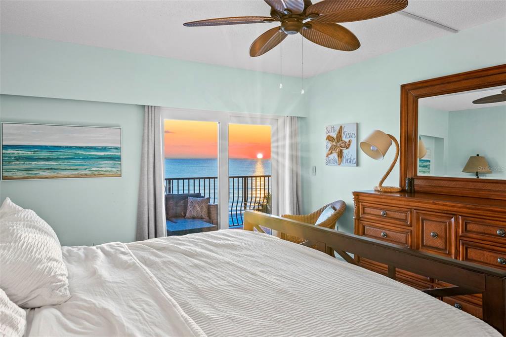 13650 Gulf Boulevard, Unit 604 Madeira Beach, FL 33708 - Photo 33 of 71 a bedroom with a bed and a chandelier