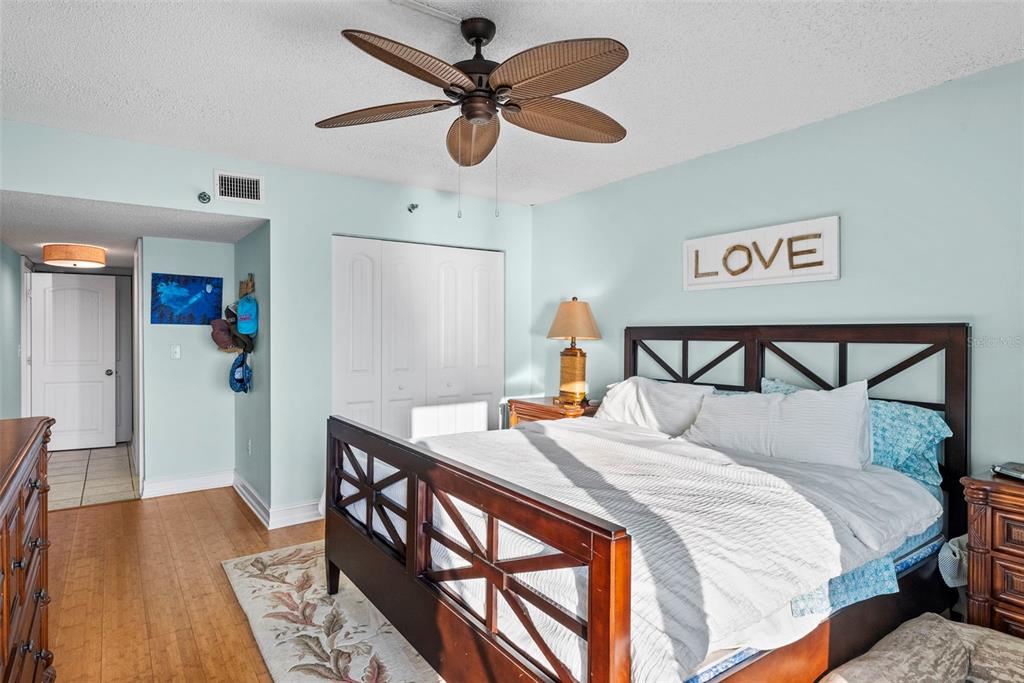 13650 Gulf Boulevard, Unit 604 Madeira Beach, FL 33708 - Photo 34 of 71 a bedroom with a bed and wooden floor