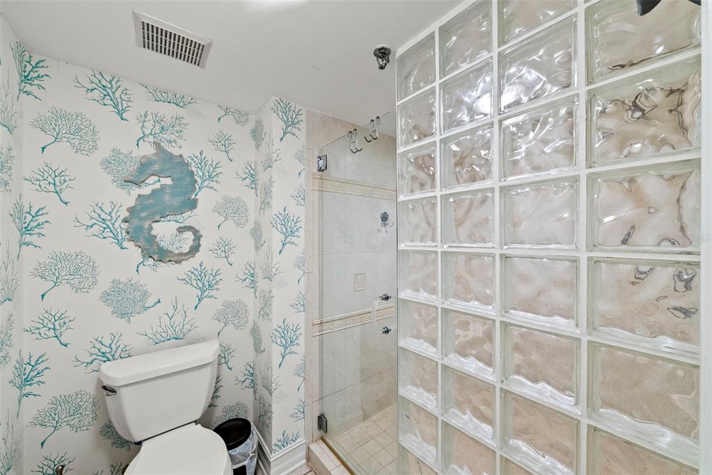13650 Gulf Boulevard, Unit 604 Madeira Beach, FL 33708 - Photo 37 of 71 a bathroom with a toilet and a shower